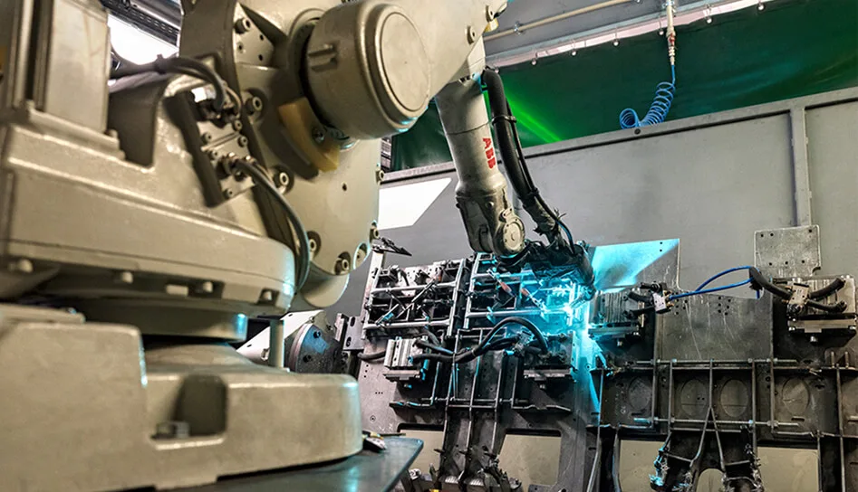 A welding robot joining a pram frame
