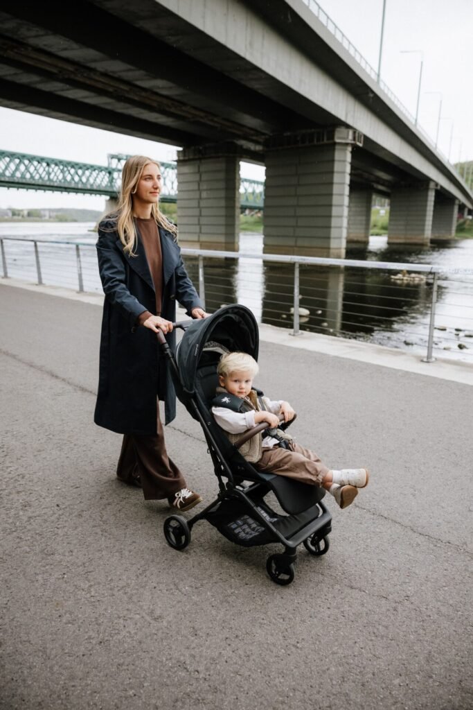 Mother walking with Sia along the river under a bridge