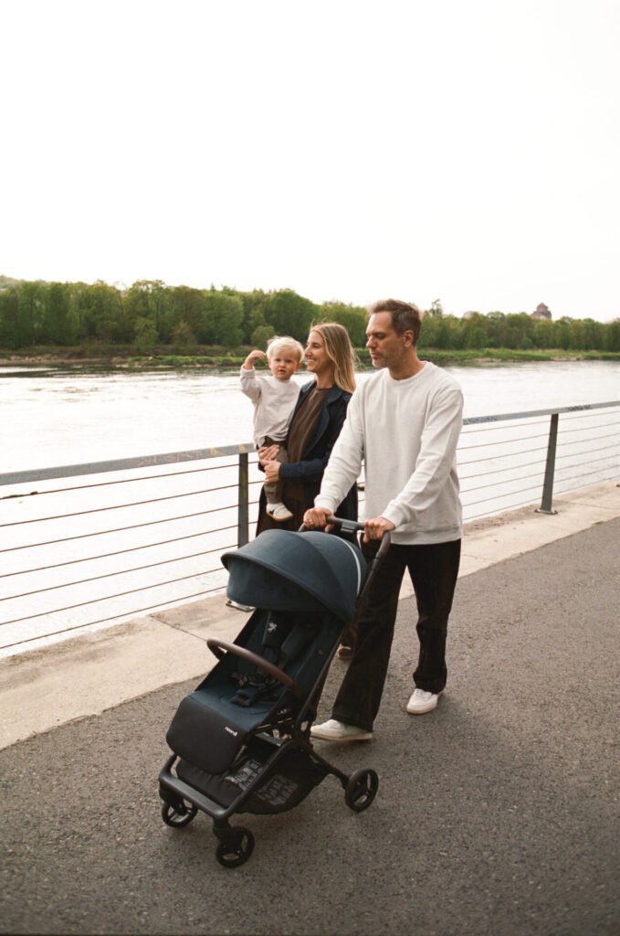 A family out for a walk with Sia by the river