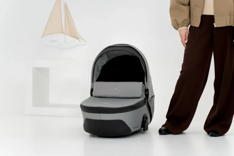 Aqua carrycot resting on the floor