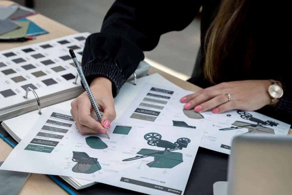 A Noordi designer sketching pram shapes and colours